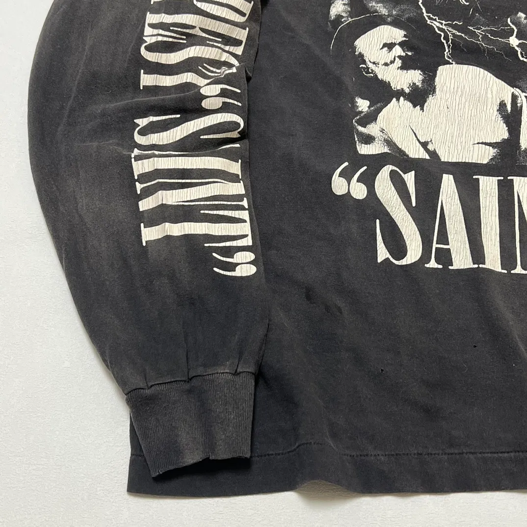 SAINT Mxxxxxx LS TEE/TEMPEST/BLK 'TEMPEST SAINT' Storm Religious Saints Cracked Retro Vulcanized Heavy Wash Long Sleeves Washed Black S-XL Assute Dyeing Multi-bit Horse Fading Craftsmanship Grinding and Hanging Holes Full of Old Feeling Top Printing Craftsmanship Purchasing Level